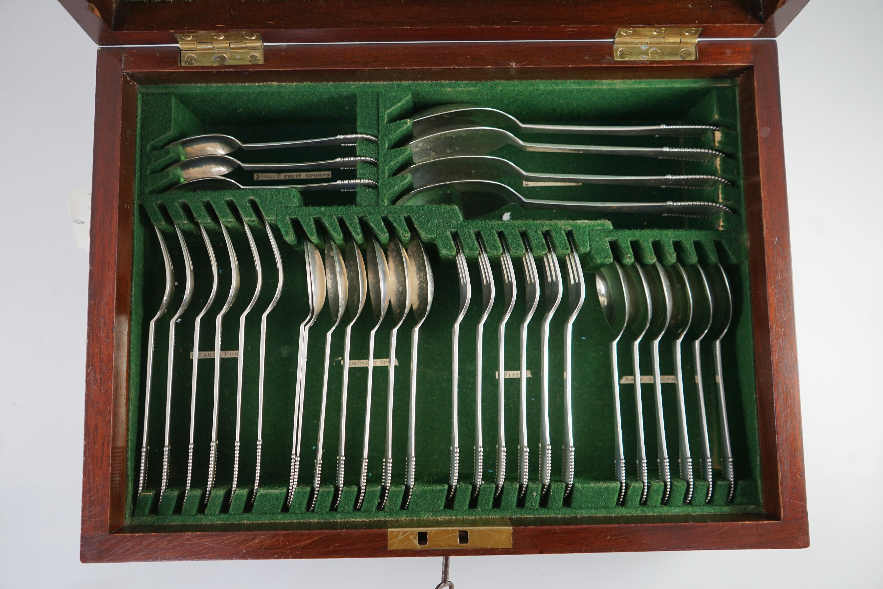 An early 20th century Georg Jensen canteen of beaded pattern silver cutlery